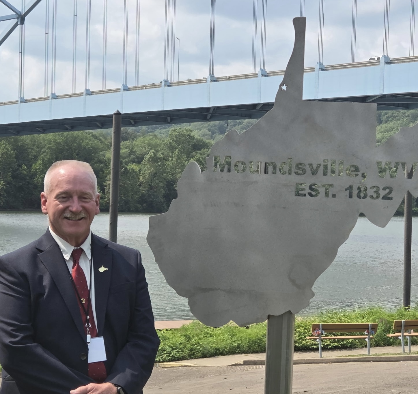 Jim Kudlak at the Welcome to West Virginia monument at Moundsville Riverfront Park